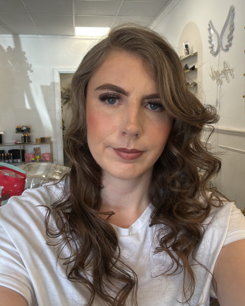 Portrait of Demi Taylor Nimmo with long wavy brown hair, wearing a white t-shirt